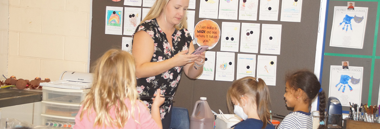 Educator working with students in classroom
