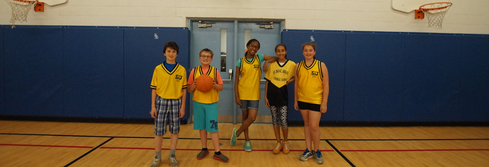 Five members of the St. Isaac Jogues Catholic School basketball teams.